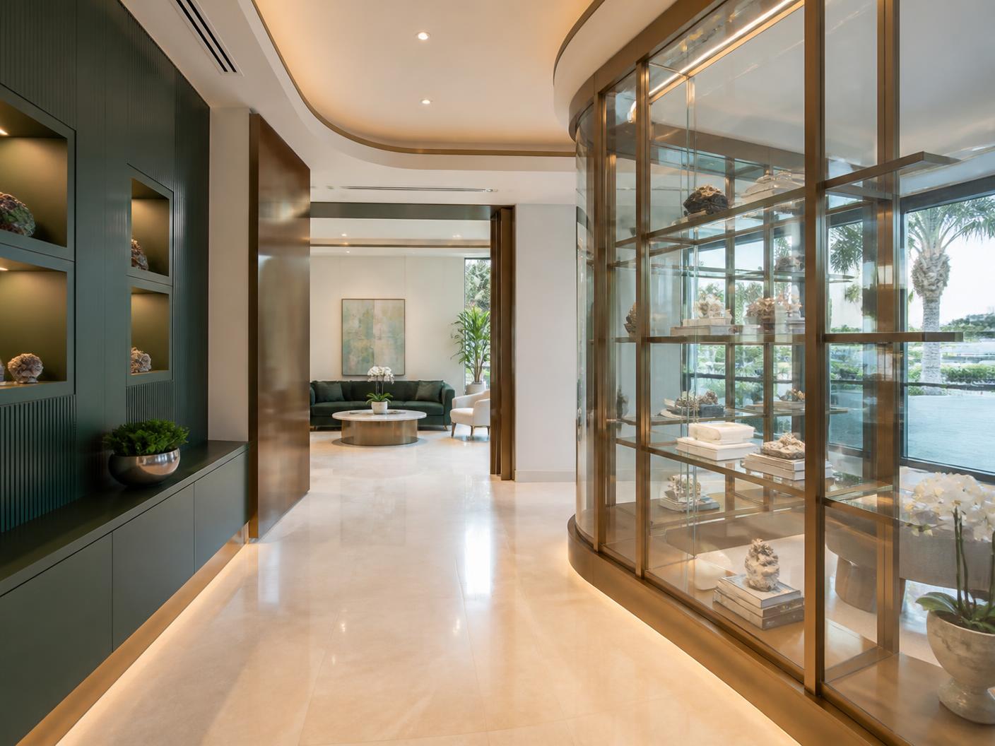 Completed luxury commercial interior renovation in Boca Raton with limestone floors, deep green millwork and bronze detailing