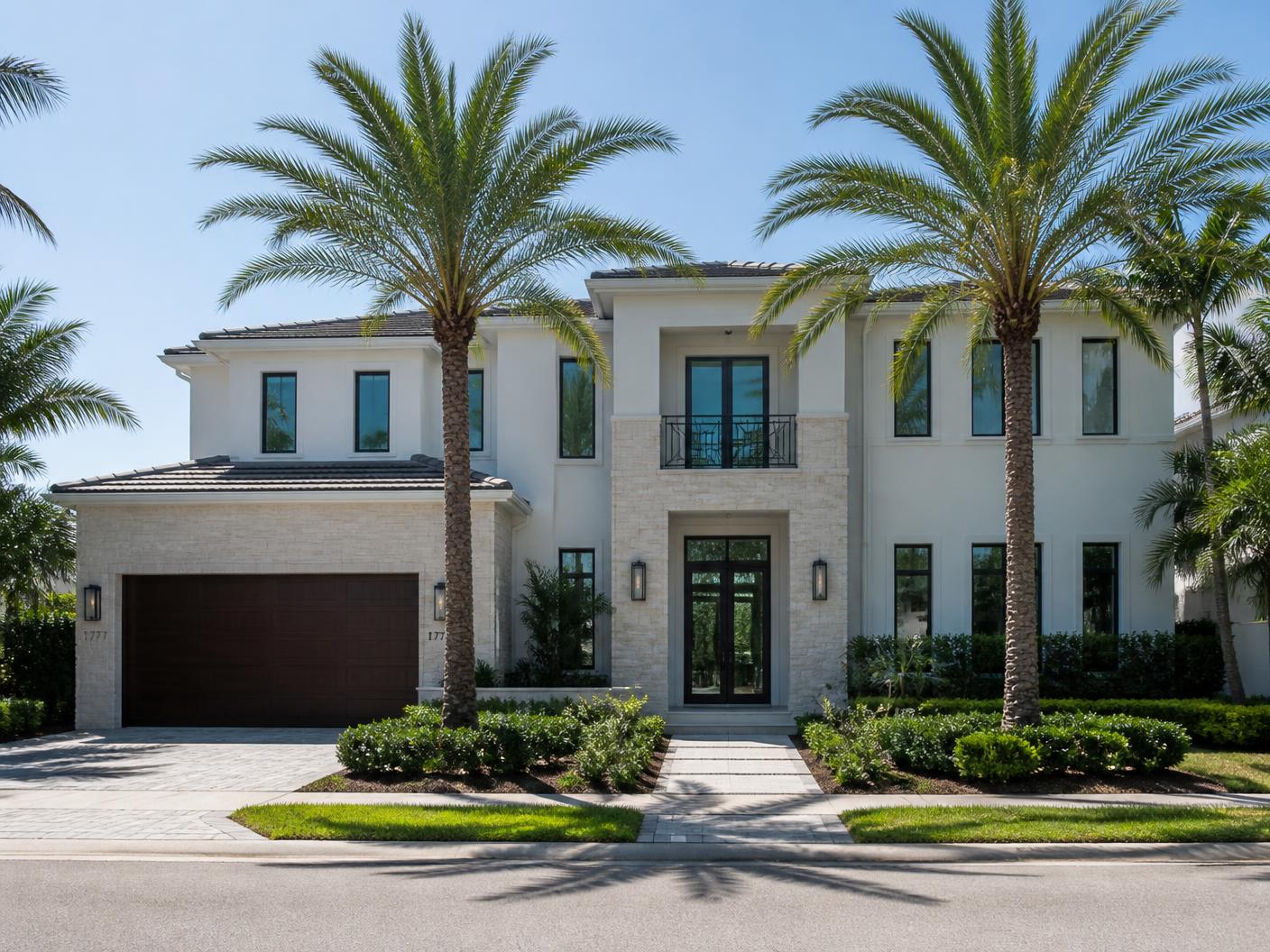 Builder reviewing custom home plans in front of a new luxury residence under construction in Boca Raton